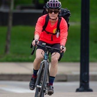 A woman rides a bicycle 