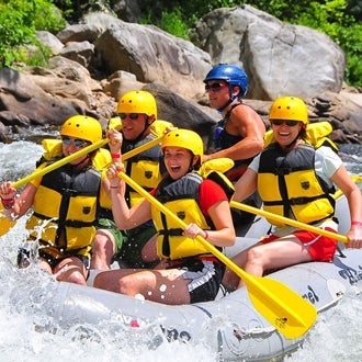 A group of people white-water rafting