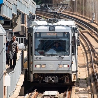 A light-rail train approaches its stop